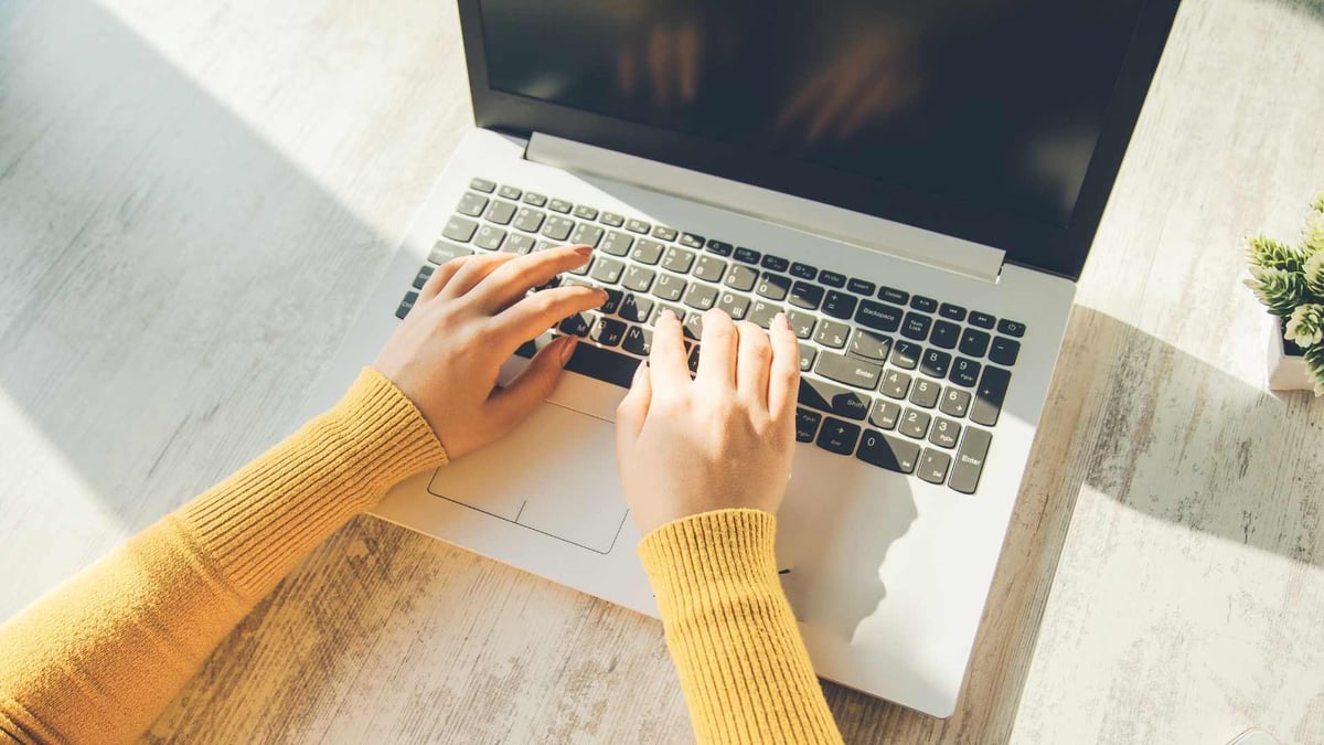 Electronics-woman-hands-on-notebook-keyboard